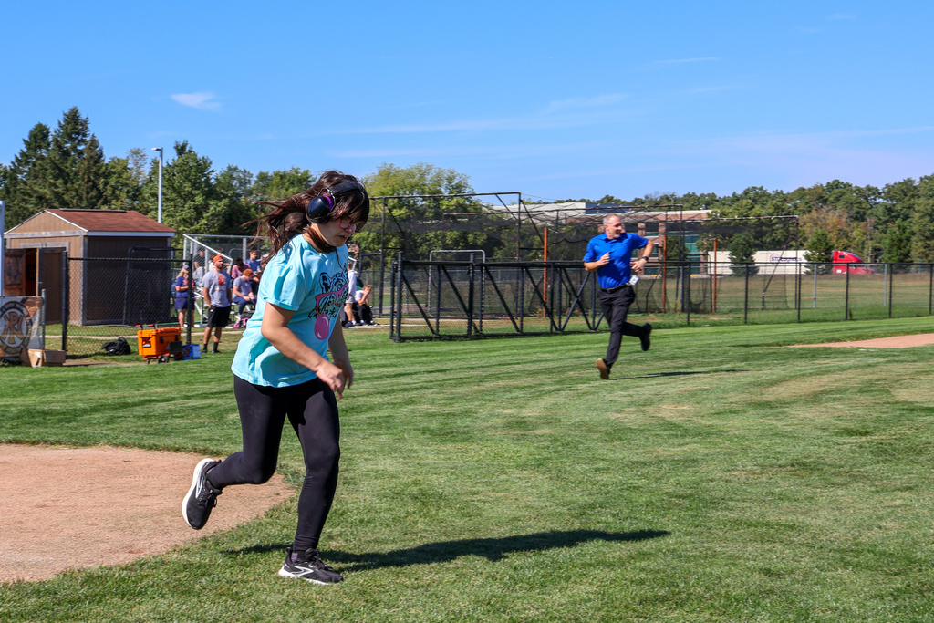 a girl running the bases on a softball field