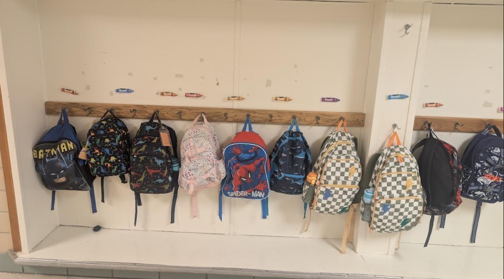 line up of backpacks in the hallway.