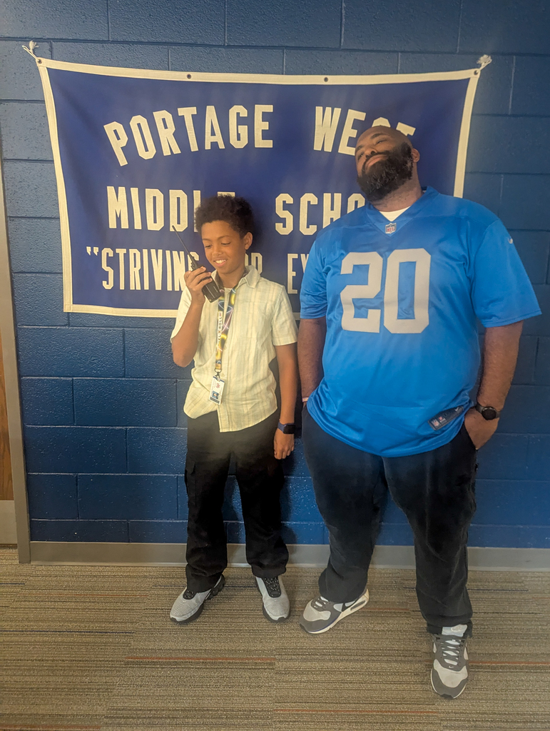 a boy and adult pose for a photo