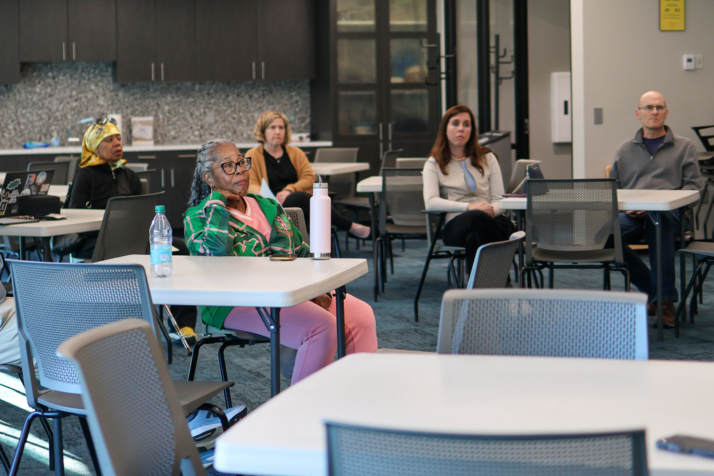 a group of people sitting in a conference room
