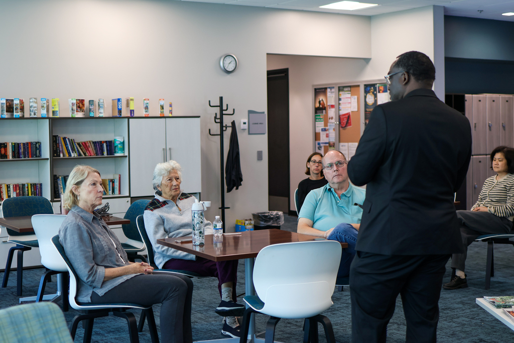a group of people sitting in a conference room