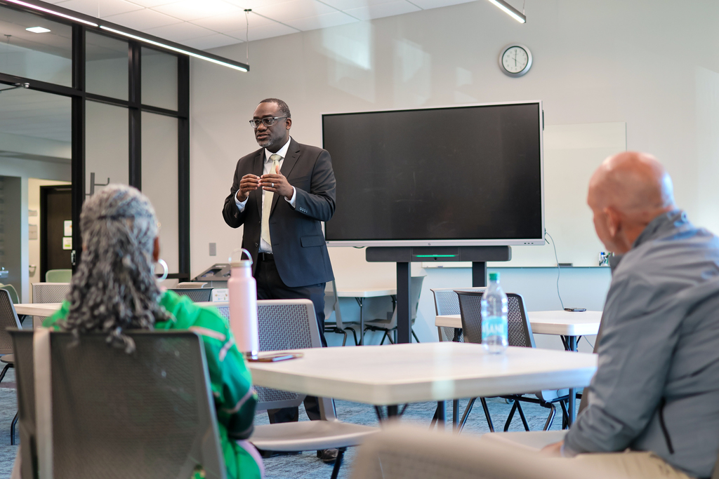 a man speaks to a group of people