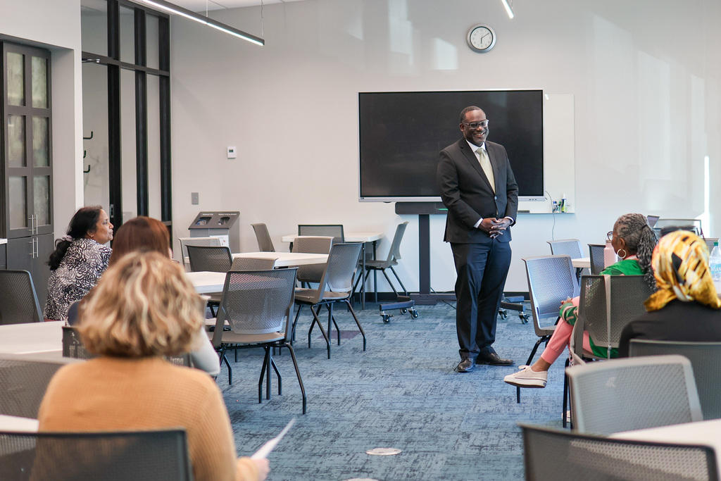 a man speaks to a group of photo
