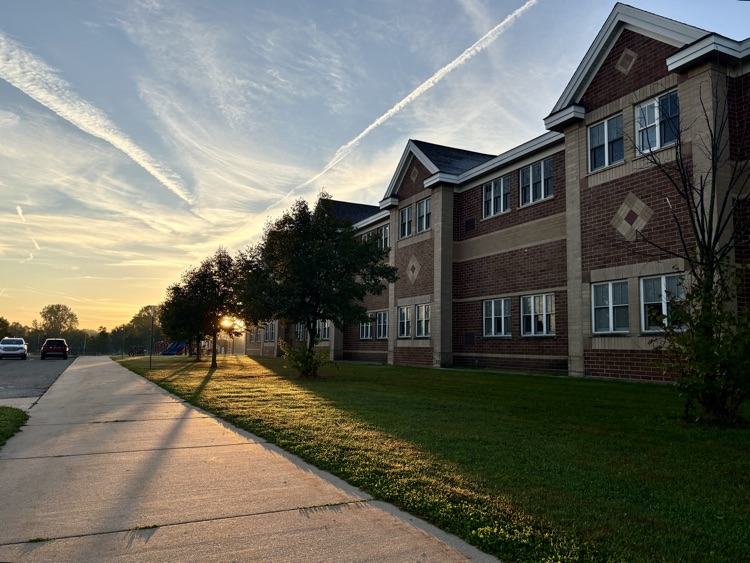 a sunrise seen next to an elementary school