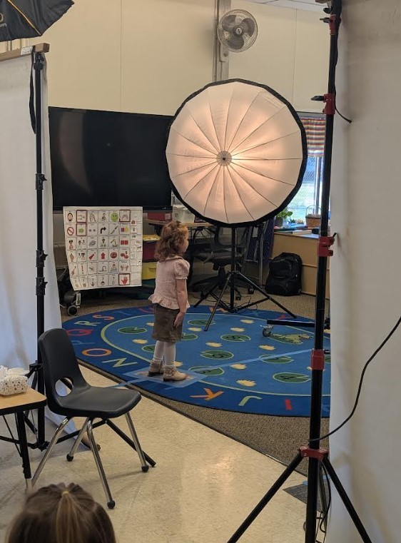 A 4 year old girl posing for a picture.