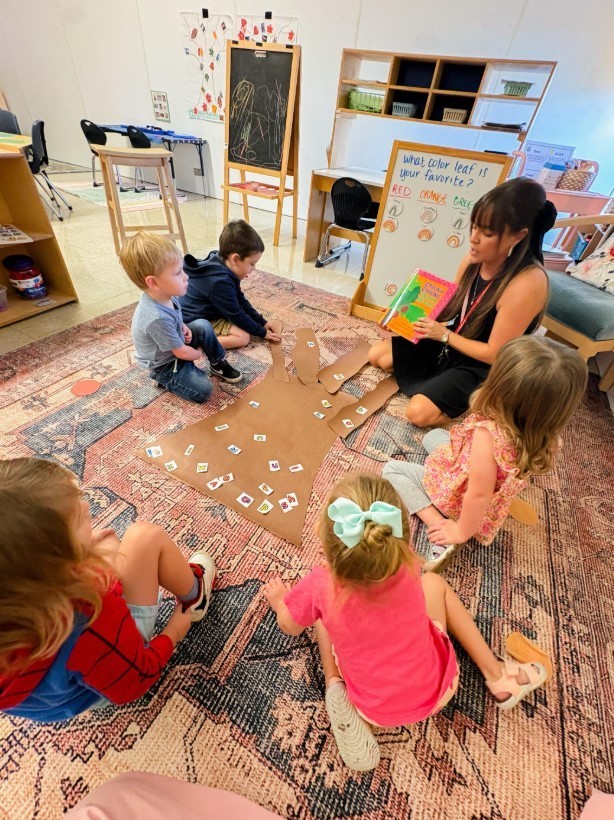 Students at the carpet working on matching items.