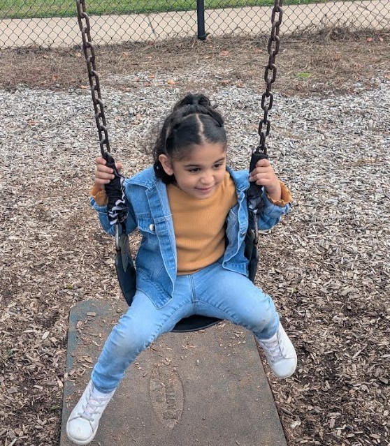 A young girl on a swing.
