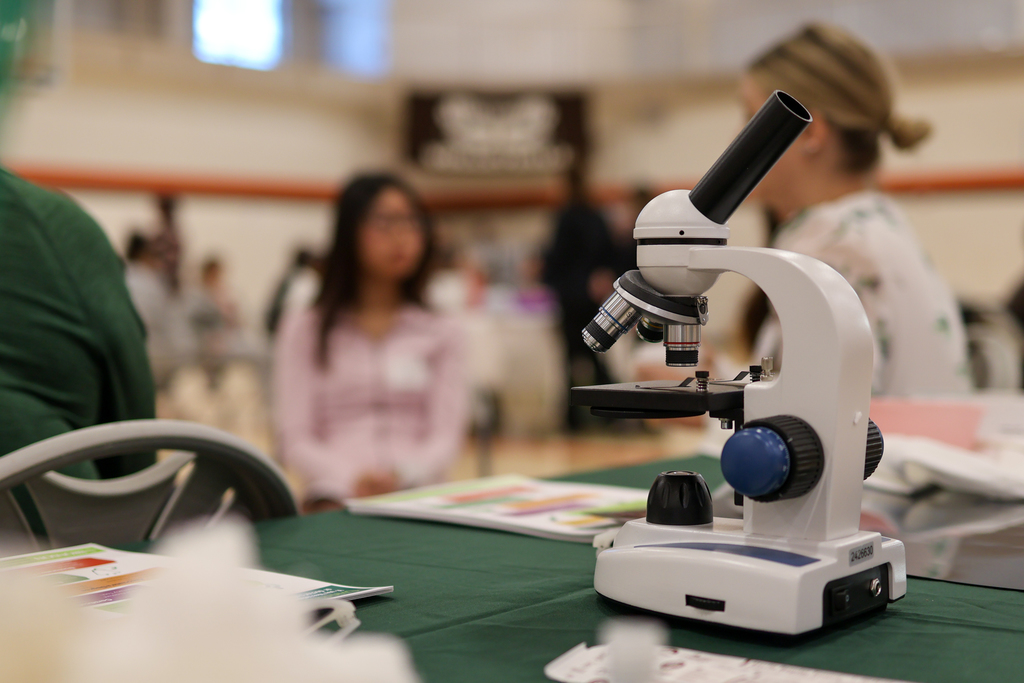lab equipment sitting on a table with students in the background