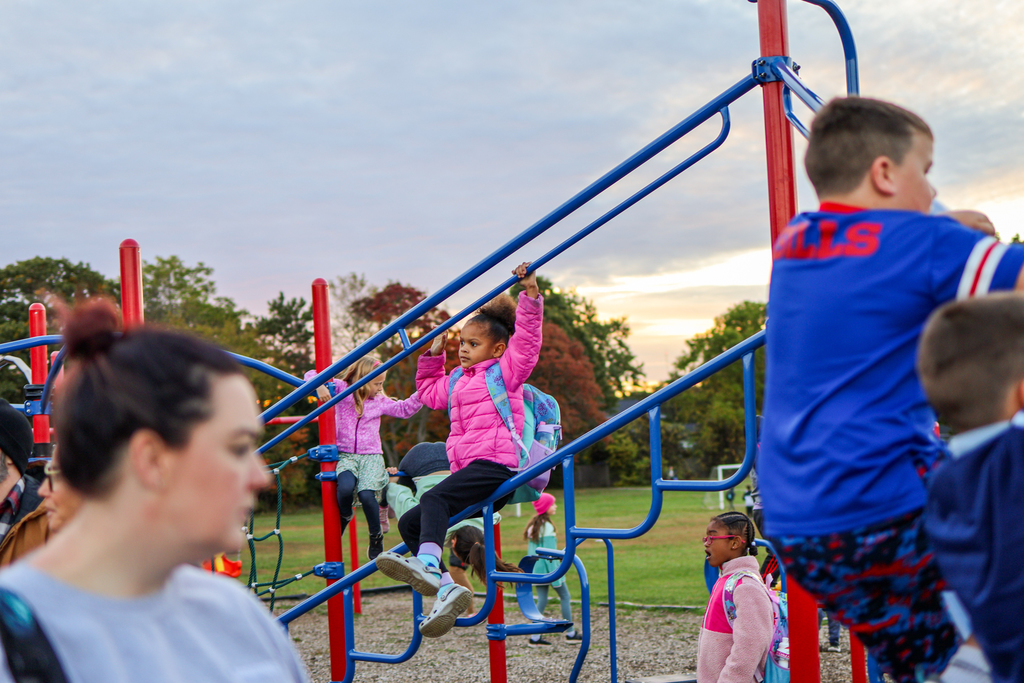a girl playing on the playground outside