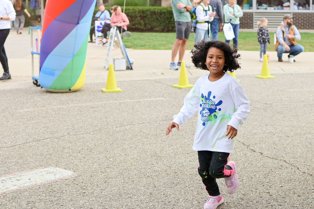 a girl running outside an elementary school