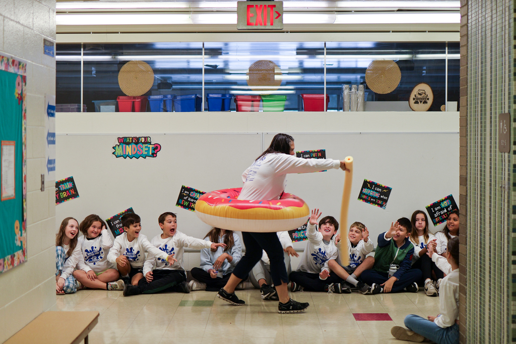 a teacher wearing a pool floatie with students