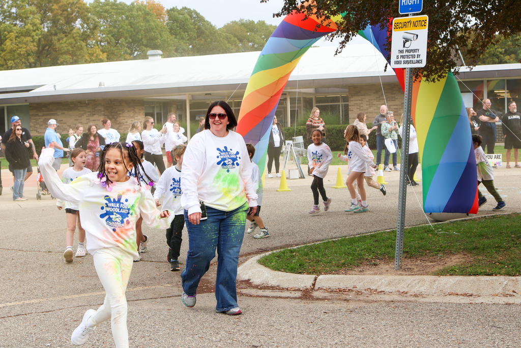 a woman walking with students outside
