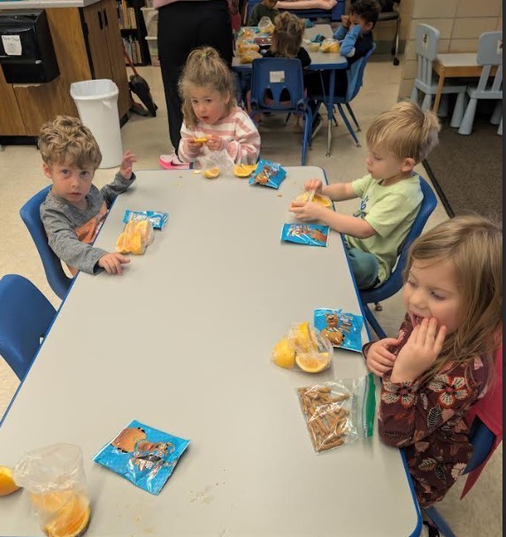 Whole class sitting together at snack time.