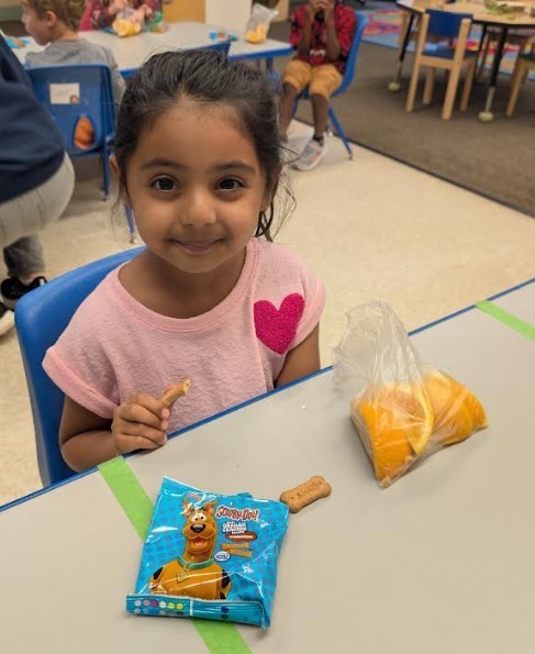 One girl eating an orange.