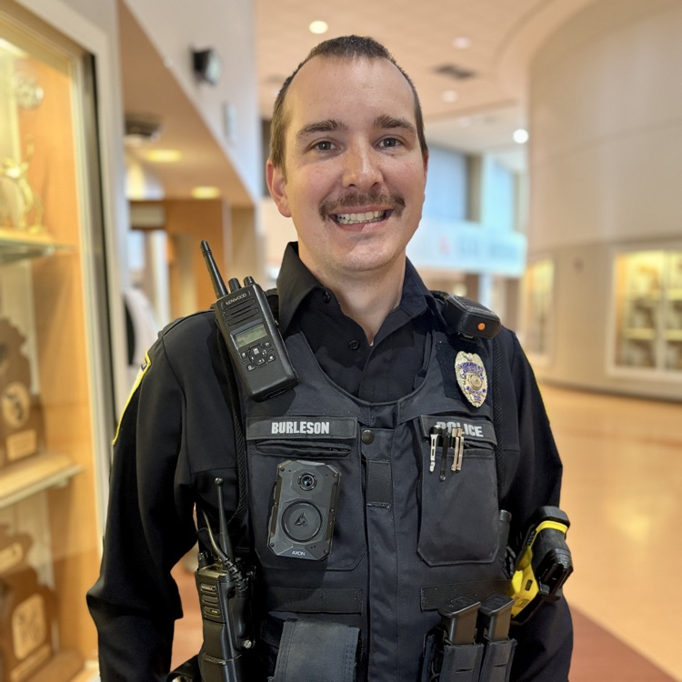 a police officer poses for a photo