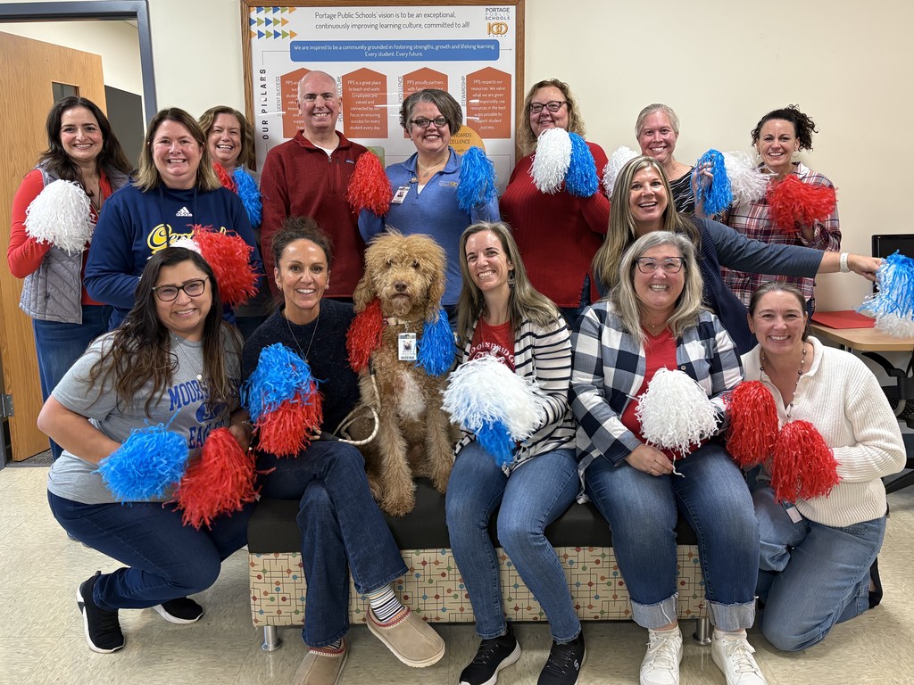 a group of people pose for a photo wearing red and blue