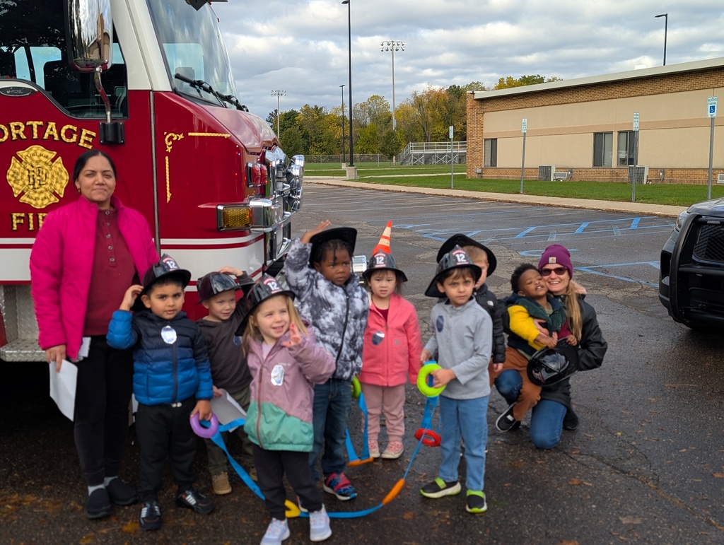 Three year olds in front of a fire truck.