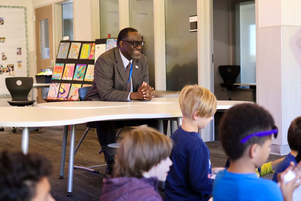 a man sitting at a table smiling