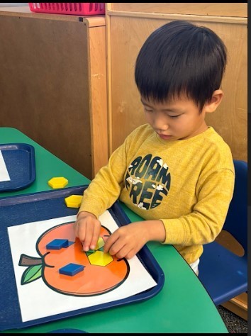 Boy painting a pumpkin. 