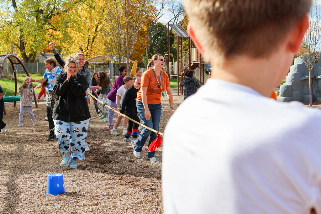 a woman cheers outside on a playground