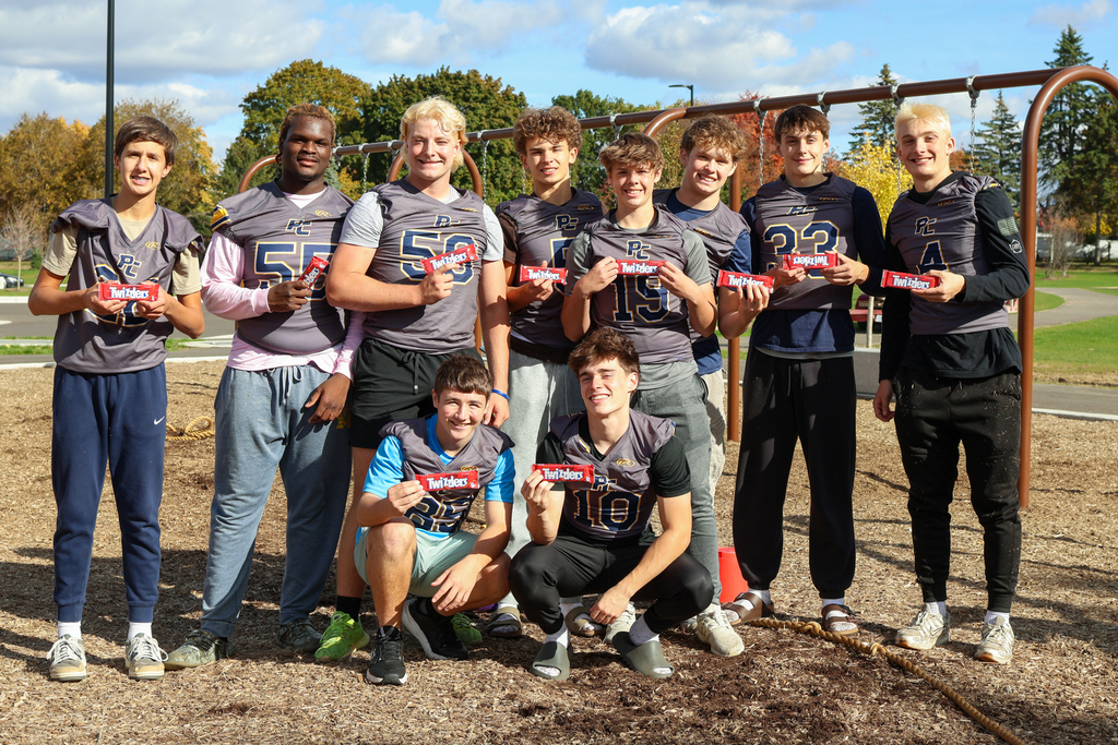 a group of high school football players pose for a photo with Twizzlers