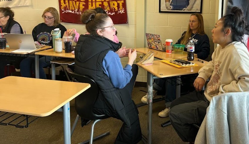 Two groups of women having a planning meeting together.