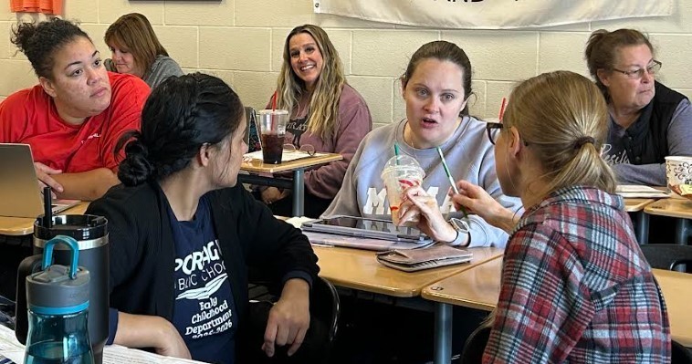 Teachers all talking and learning together.