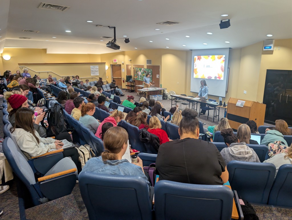 Whole group of teachers sitting together to watch a presentation.