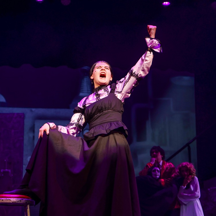 a girl signing dramatically on stage