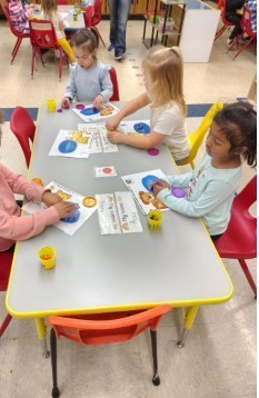 A group of students at the sensory table.