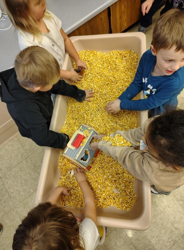 A group of students at the sensory table.