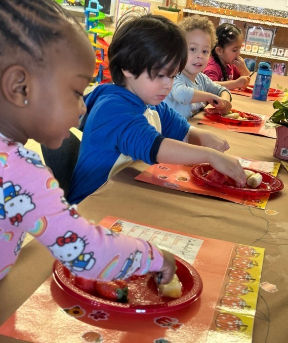Students making fruit salad.