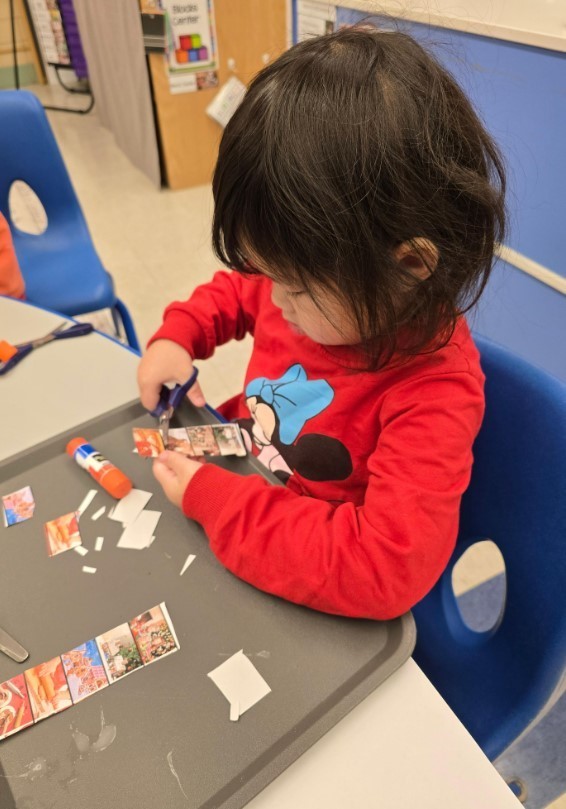 Student cutting at her own table.