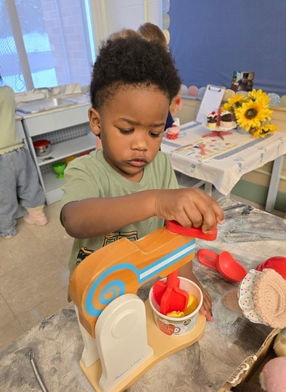 A male student at the dramatic play area.