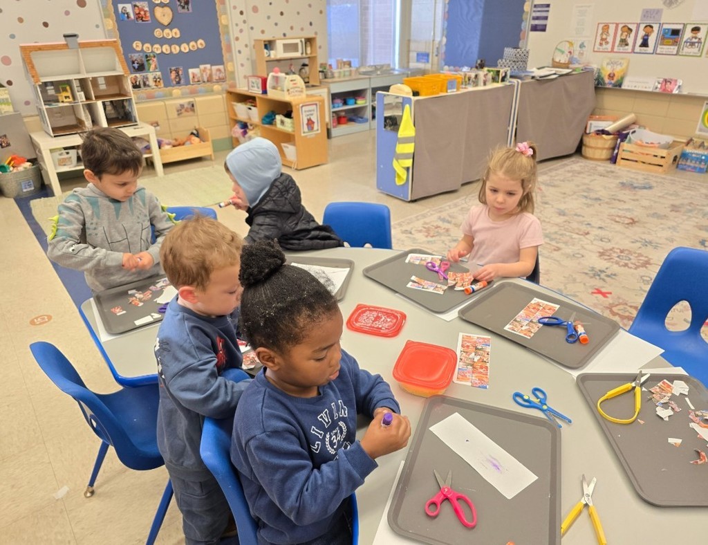 Students cutting and glueing together.