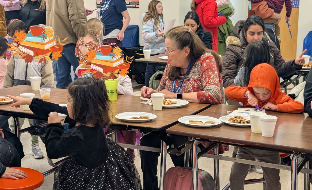 A view of the cafeteria where our families are enjoying pizza, cookies and each other.