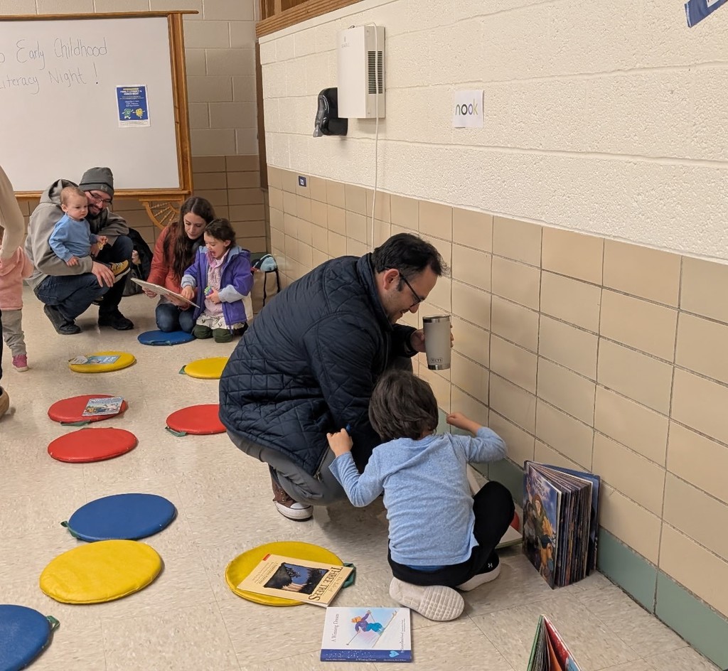 A father and son looking at books.
