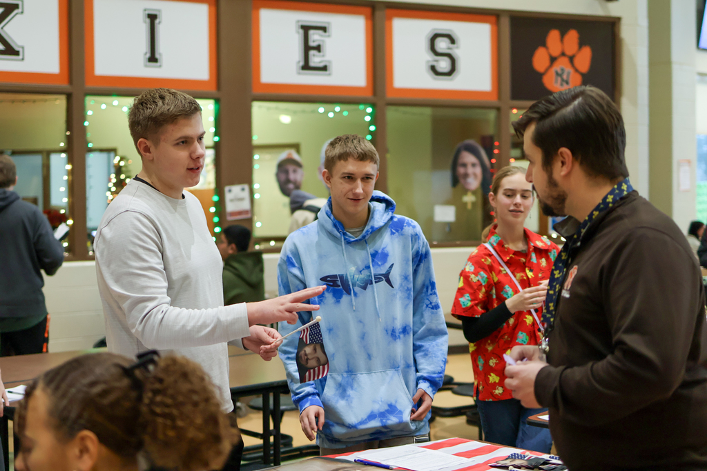 boys talking to a teacher in a school cafeteria