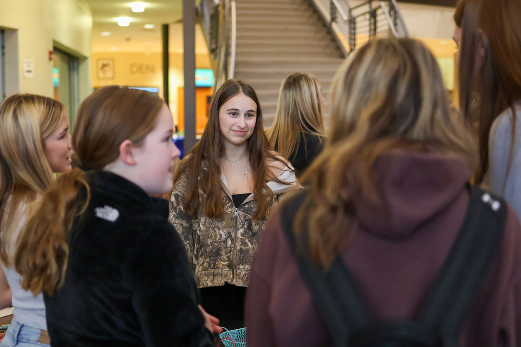 a girl smiling at friends in a school