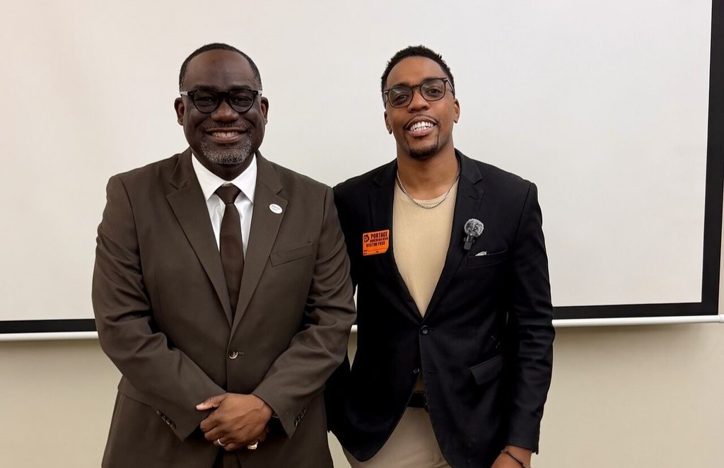 two men pose for a photo