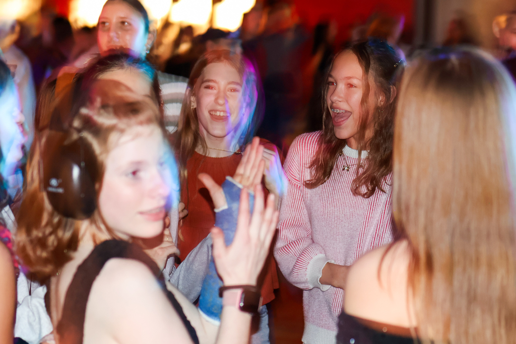 girls dancing on a dance floor with strobe lights