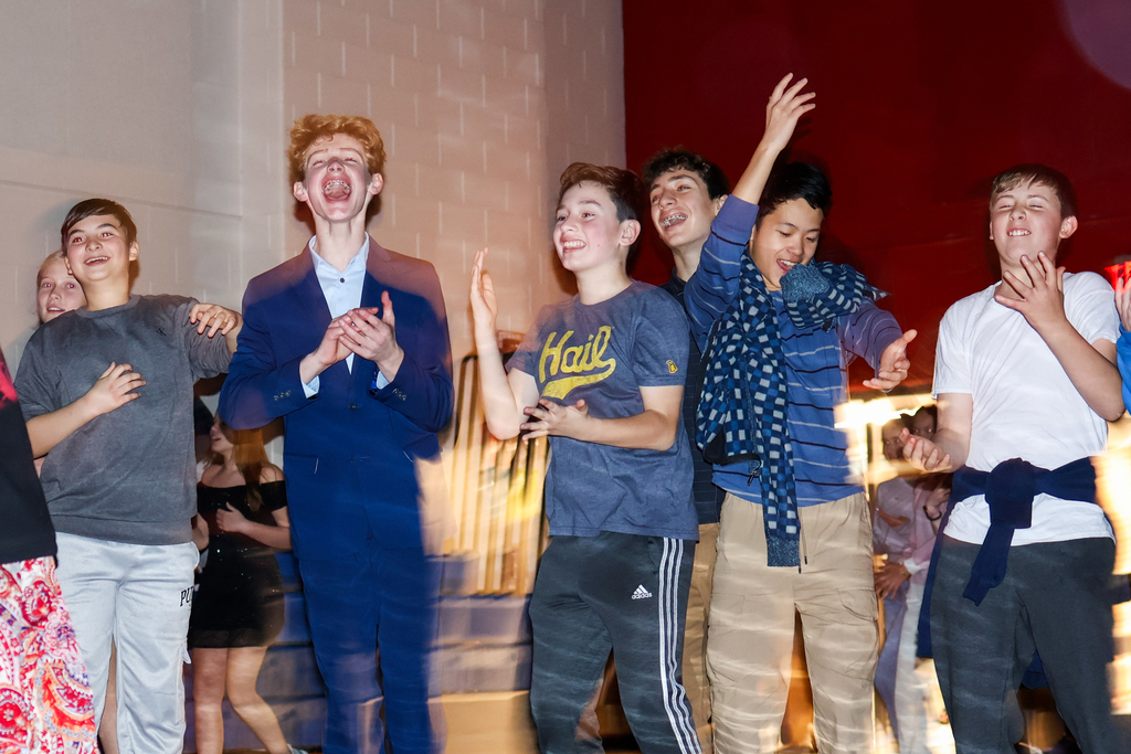 a group of boys dancing on the dance floor