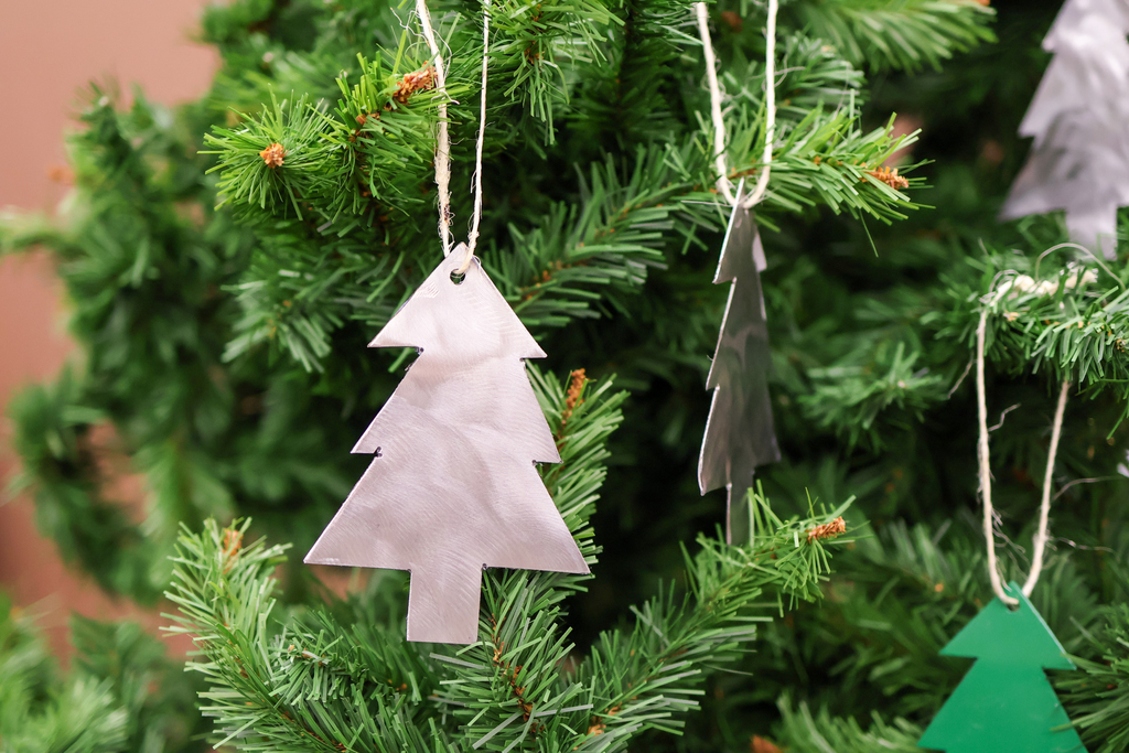 metal ornaments hang from a tree