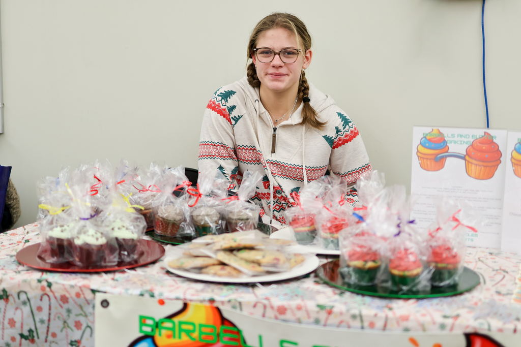 a student poses for a photo next to her baking
