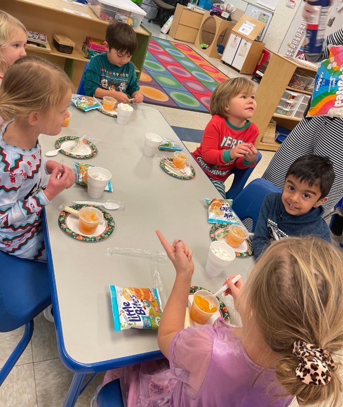Children eating a snack together.