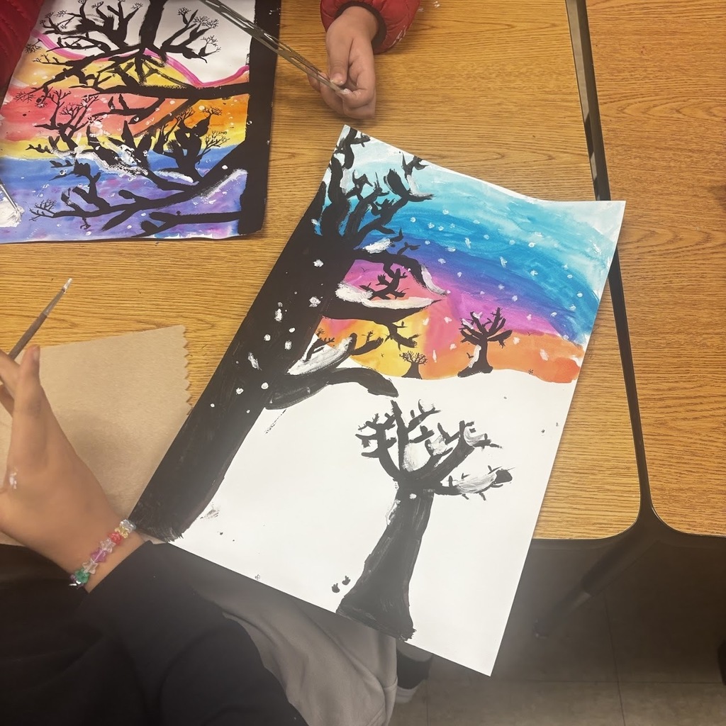 students painting landscape scenes at a desk