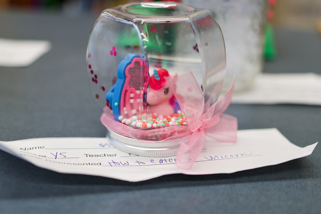 a snow globe with a pink pony inside