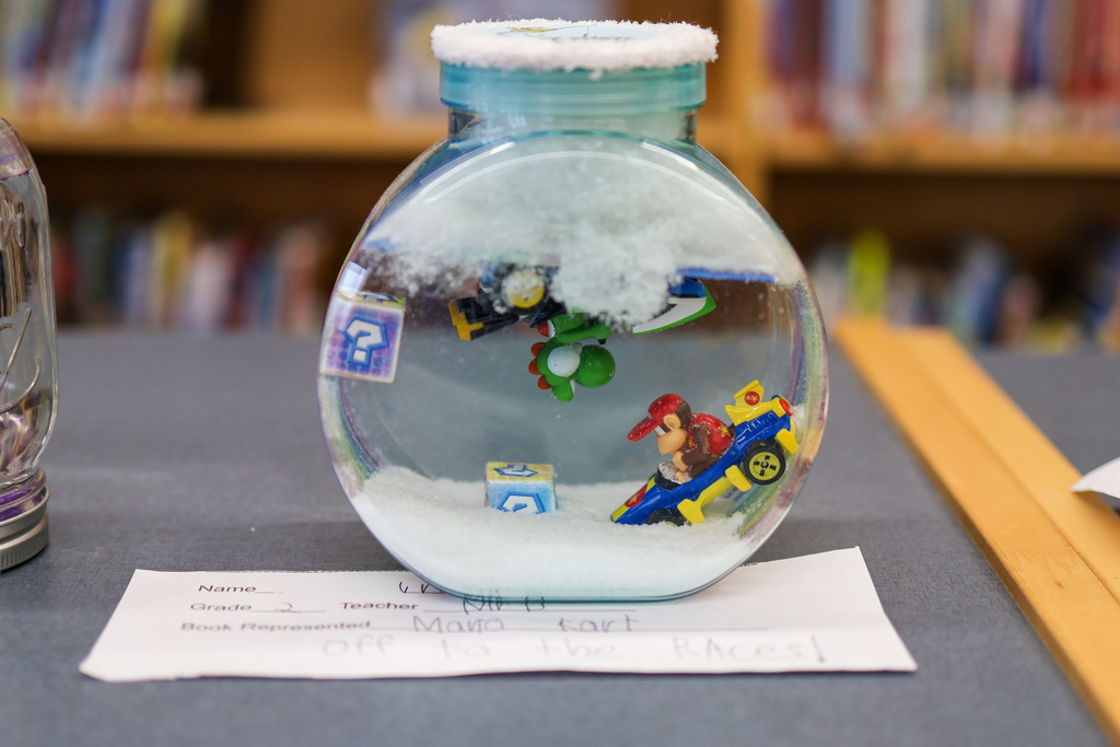 a snow globe with characters from mario kart inside