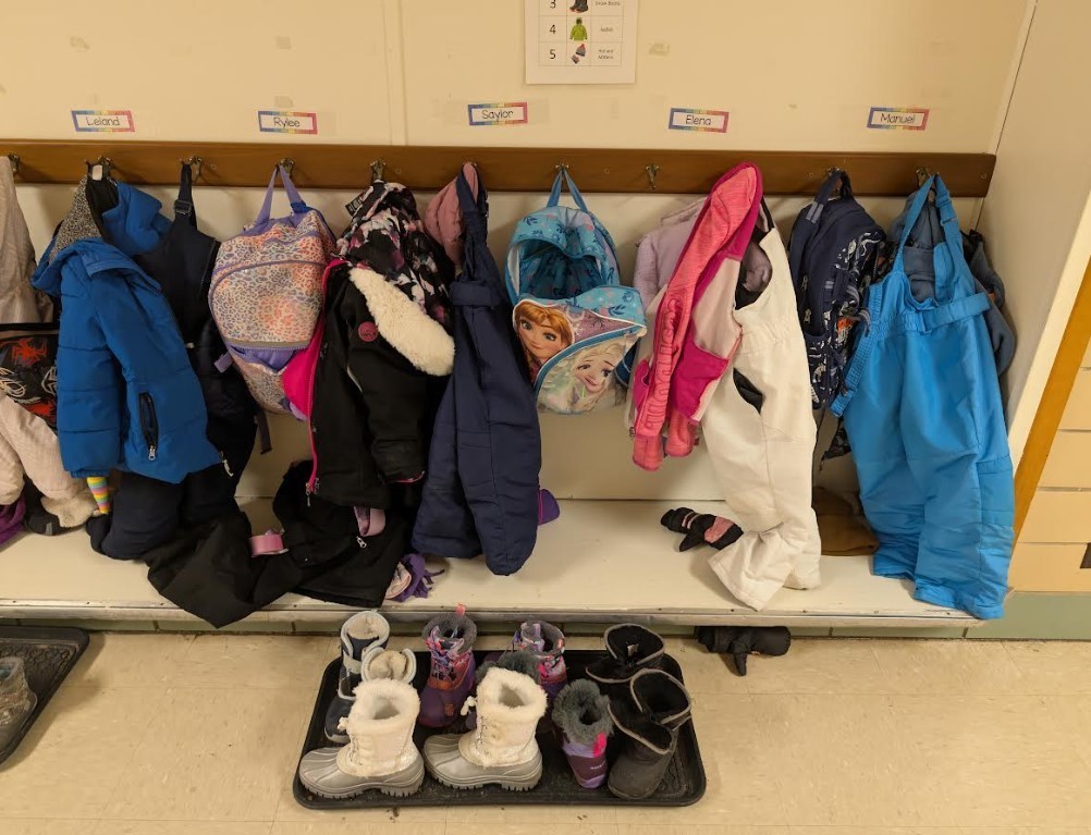 Hallway with coats and boots lined up.