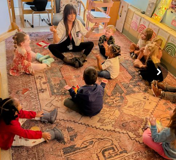 Students practicing yoga together at the rug.